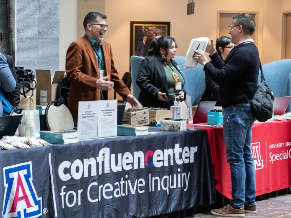 A group conversation at a Confluence Center event booth