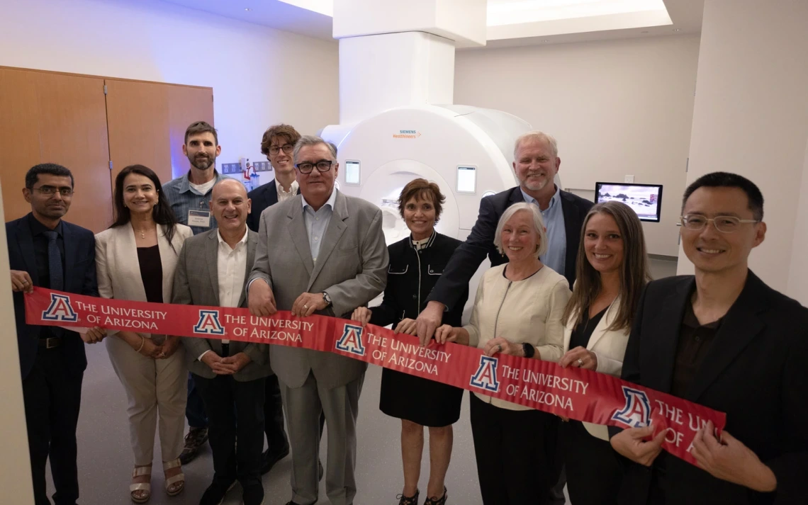 ribbon-cutting ceremony in front of MRI machine