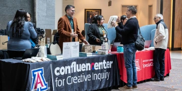 A group conversation at a Confluence Center event booth